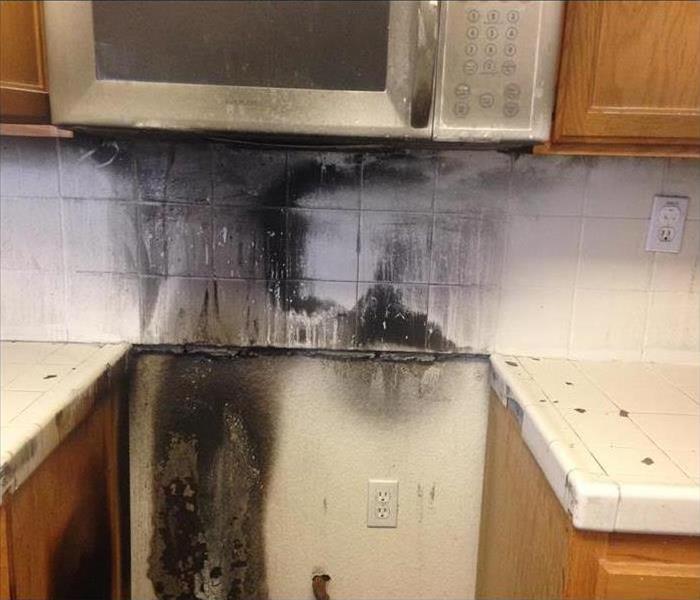 Space where oven was is empty with scorch marks