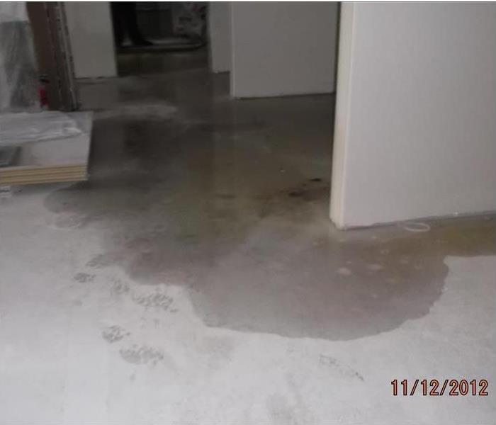 Grey flooring with water all over it