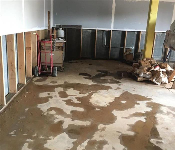 Photo of commercial area with water all over the grey floors