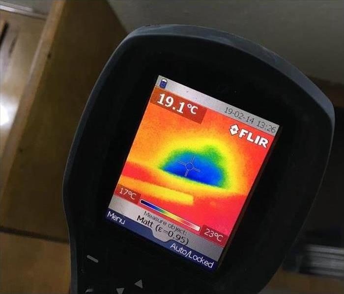 Photo of thermal image. Image is mostly red with a patch of blue