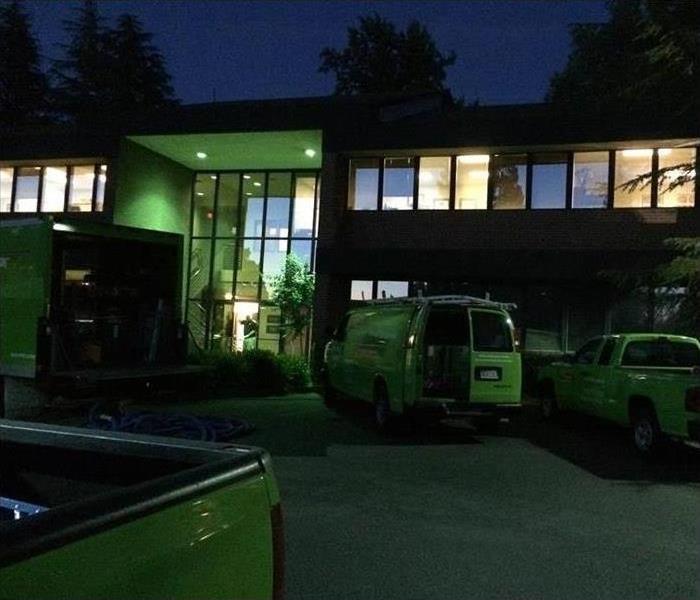 Commercial building with SERVPRO trucks in front of it